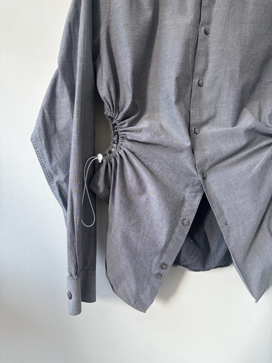 Gray button-up shirt with a tie detail on a white background